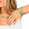 Bracciale Oceania waterproof color oro con smalto turchese e verde acqua e chiusura a scatto.