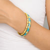 Bracciale Positano color oro in acciaio inossidabile waterproof con finitura smaltata azzurra e gialla su sfondo bianco.
